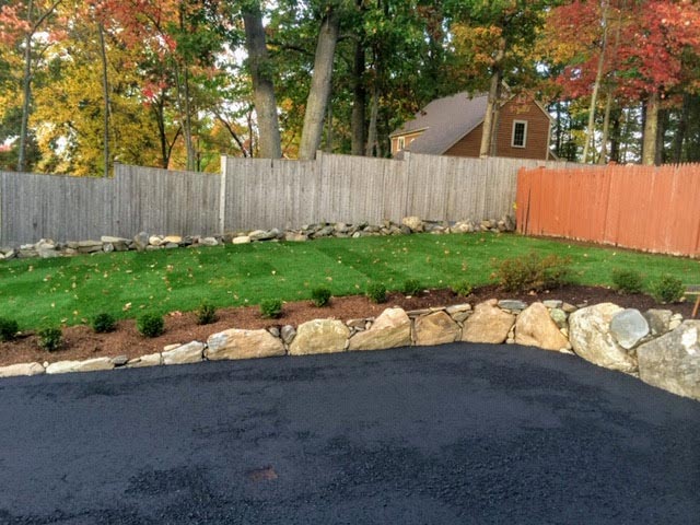 Stone hardscaping around a driveway.